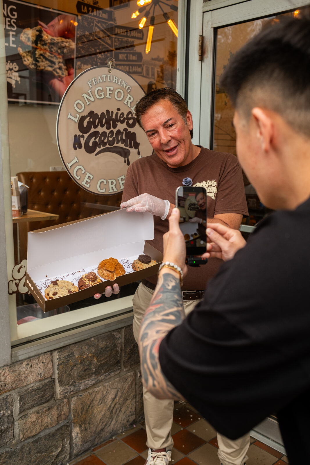 SparkTrail videographer filming Cookies N' Cream founder content outside the storefront