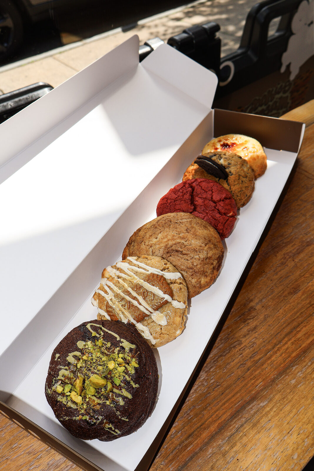 Open box of assorted Cookies N' Cream gourmet cookies including M&M and chocolate chip flavors
